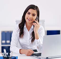 Businesswoman talking on cellphone in office